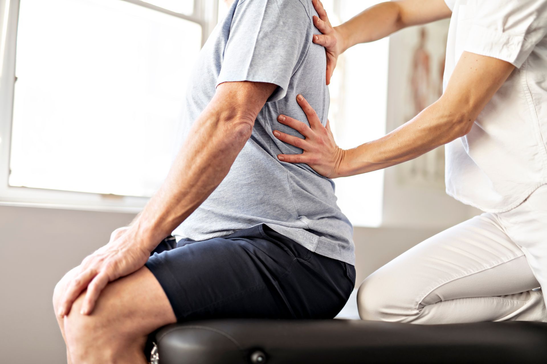Physiotherapist treating a patient's back